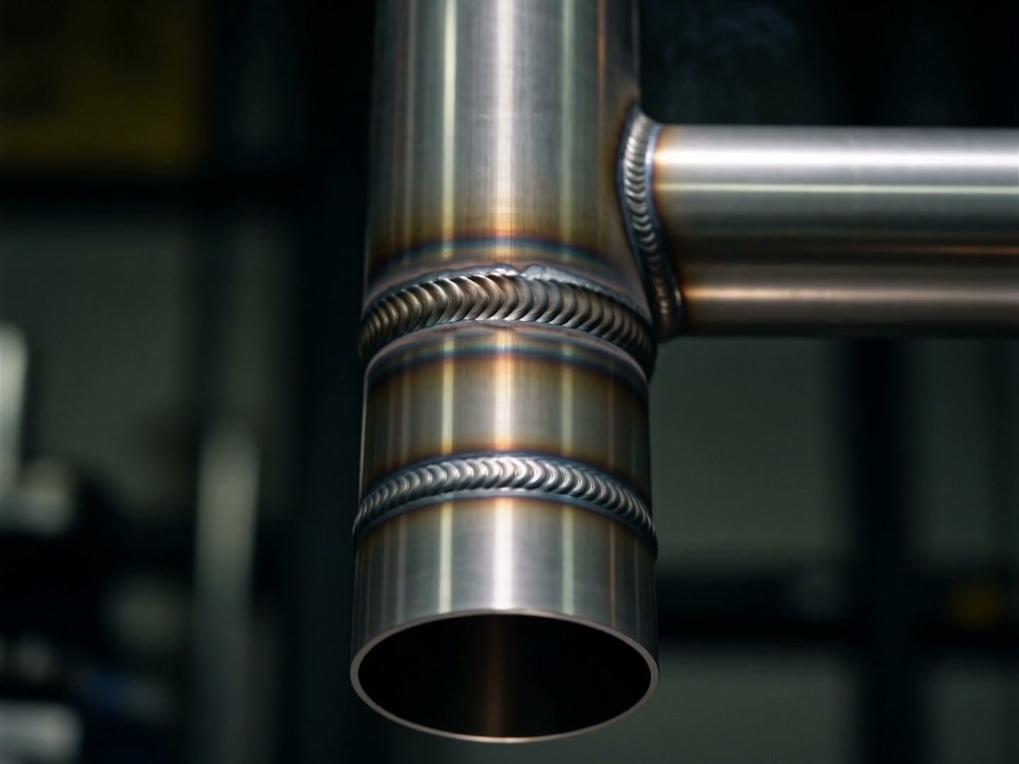 A finished stainless steel merge collector with two clean TIG welds, fresh off the bench